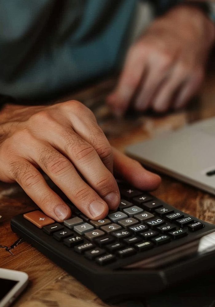person-using-financial-calculator-planning-their-savings-investments-scaled-quxjyv6v7spljjbc20oqa6y8f48niwv2wyz42ky61c.jpg